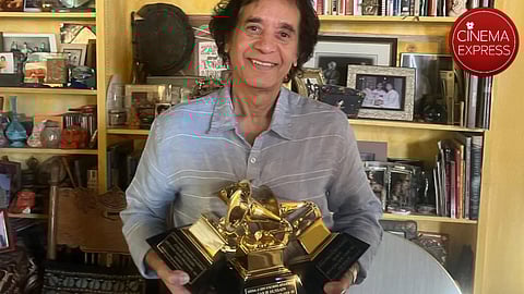 Zakir Khan holding his three Grammy awards